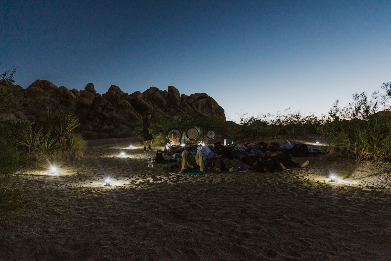Group of people at a nighttime gong sound bath at Joshua Tree National Park